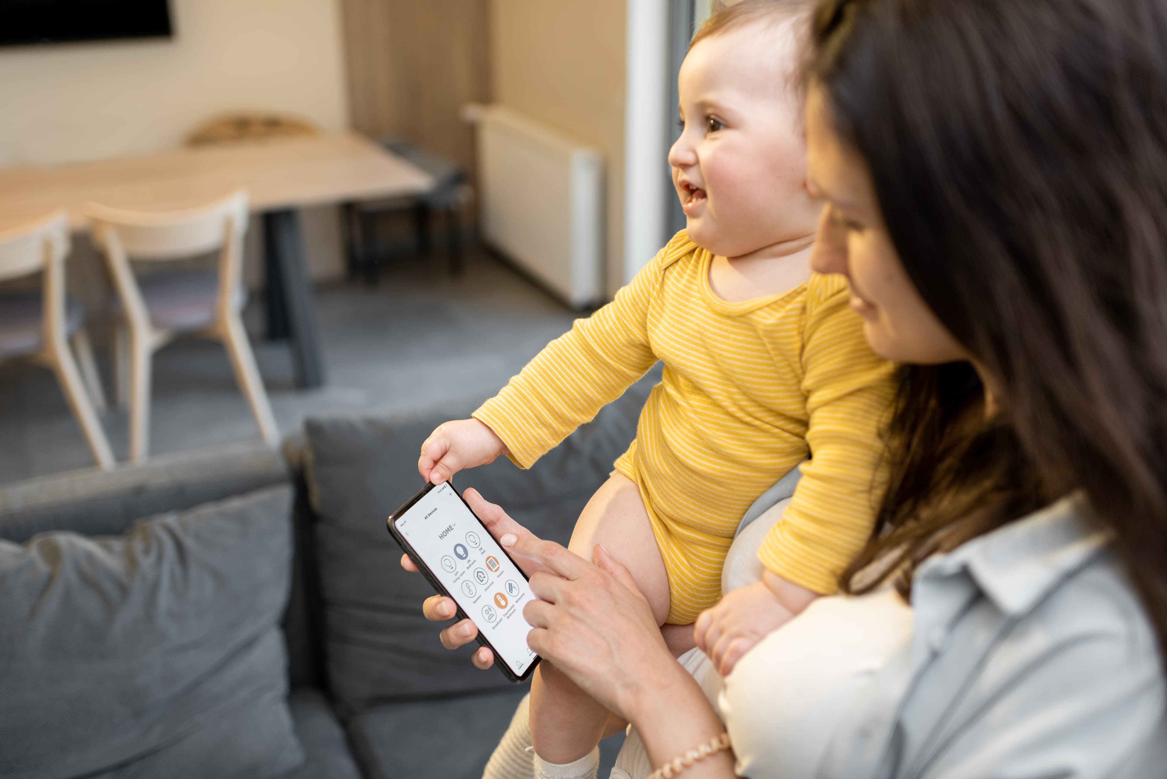 Mother using ParentPal app with baby